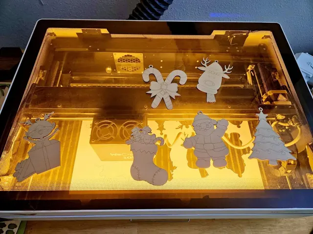 Wooden Christmas shapes being cut on the laser